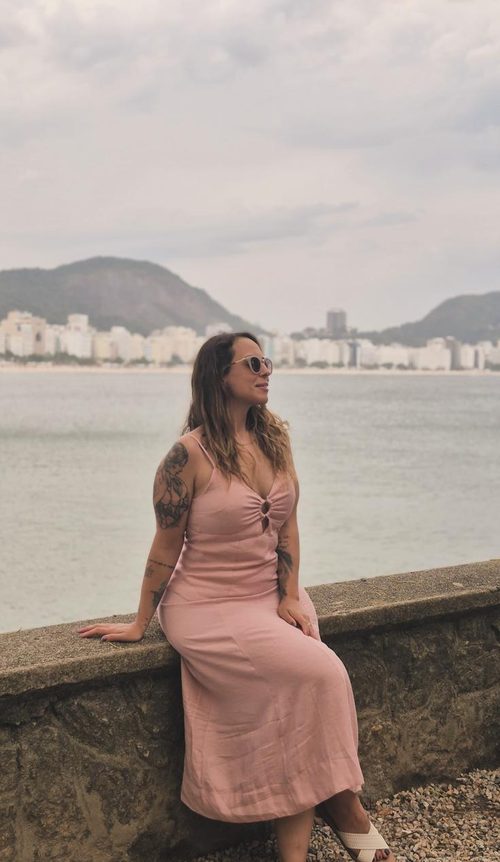 Júlia viajando, à beira-mar